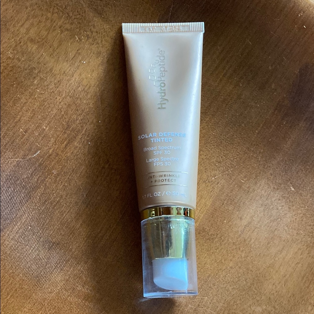 Open and unused HydroPeptide Solar Defense Tinted SPF 30 Cream